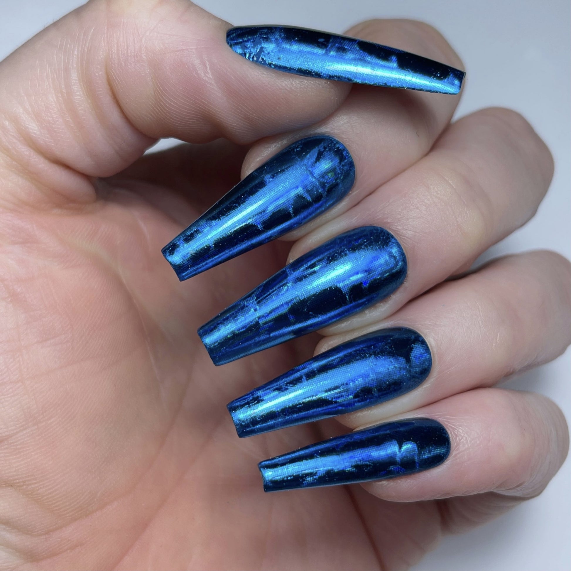 blue holo animal foil on hands